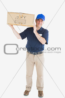 Mature courier man carrying cardboard box