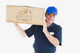 Happy delivery man carrying package