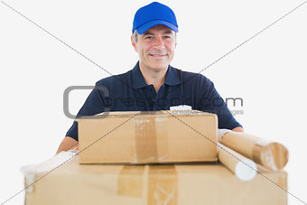 Happy mature courier man carrying cardboard boxes