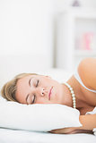 Sleeping woman with white pearls necklace