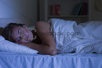 Cute woman sleeping at night