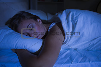 Blonde woman sleeping at night