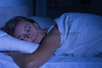 Serene woman sleeping at night