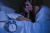 Unquiet blond woman in the bed at night