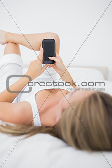 Concentrated woman looking at her phone
