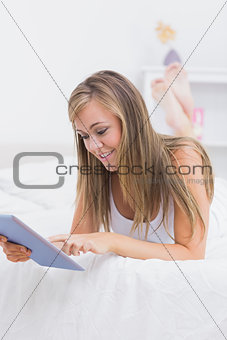 Happy woman touching her tablet pc