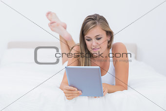 Blonde woman touching her tablet pc