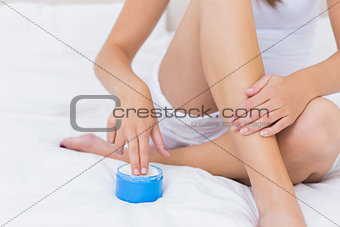 Woman putting some moisturising cream