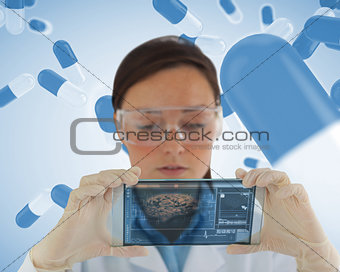 Serious nurse holding a virtual screen