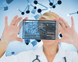Joyful blonde nurse holding a virtual screen