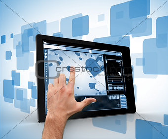 Hand touching a digital tablet
