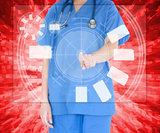 Woman in scrubs standing against a red background