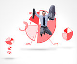 Businessman jumping against a graphic pie chart
