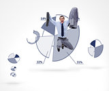 Businessman jumping against a graphical pie in background
