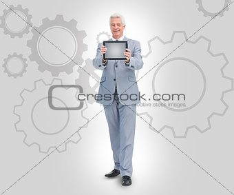 Smiling businessman holding a tablet