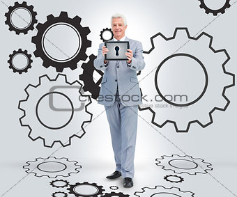 Businessman holding a tablet against a background
