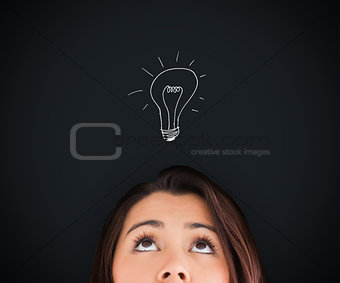 Woman looking up on the picture of bulb