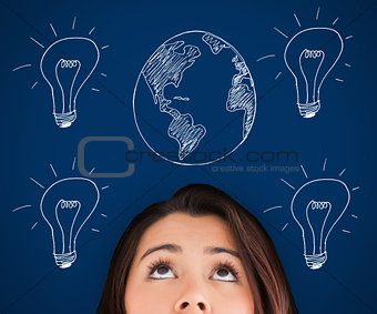 Woman standing against a picture of bulbs and globe