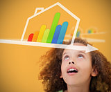 Girl looking up to energy efficient house graphic