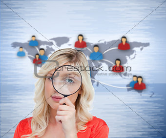 Blonde woman looking through the magnifier