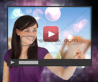 Woman touching screen with video
