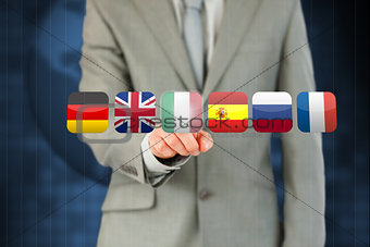 Businessmans finger activating futuristic touchscreen with various flags