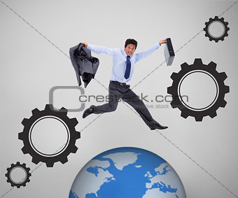 Businessman jumping above picture of the world
