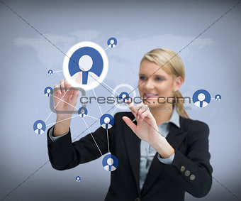 Businesswoman using touch screen with contacts on people