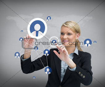 Businesswoman standing before touch screen