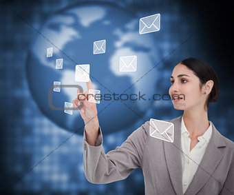 Brunette businesswoman pressing envelope on touch screen