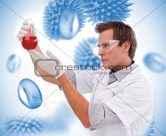 Scientist looking at beaker