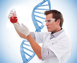 Scientist looking at beaker of blood