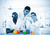 Group of smiling scientists examining testtubes