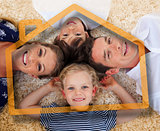 Smiling young family in front of orange house illustration