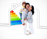 Smiling family standing with a house illustration with energy rating graphic