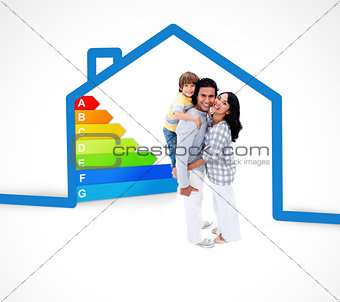 Smiling family standing with a blue house illustration with energy rating