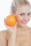 Happy woman holding fresh orange