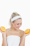 Happy woman looking at sliced orange