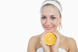 Happy woman holding slice of orange