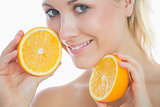 Beautiful woman holding slices of orange