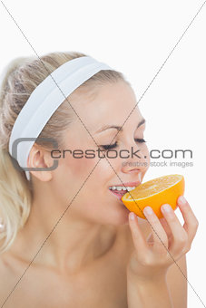 Woman enjoying slice of orange