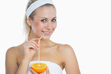 Happy young woman drinking orange juice
