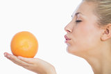 Woman blowing a kiss to orange
