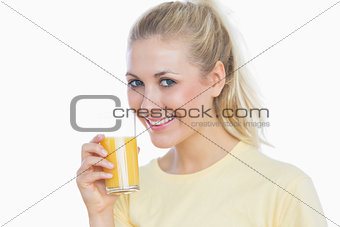 Woman holding glass of orange juice