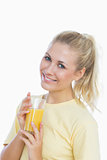 Happy woman holding glass of orange juice