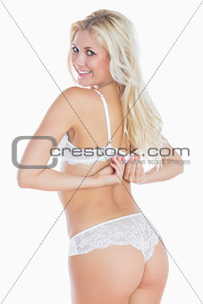 Sexy woman unhooking her bra