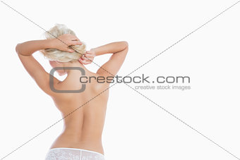 Sexy woman tying her hair