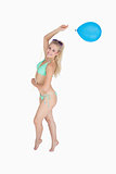 Happy woman in bikini holding balloon
