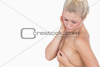 Serious woman covering her breasts