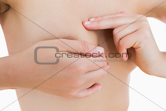Nude woman touching her breast